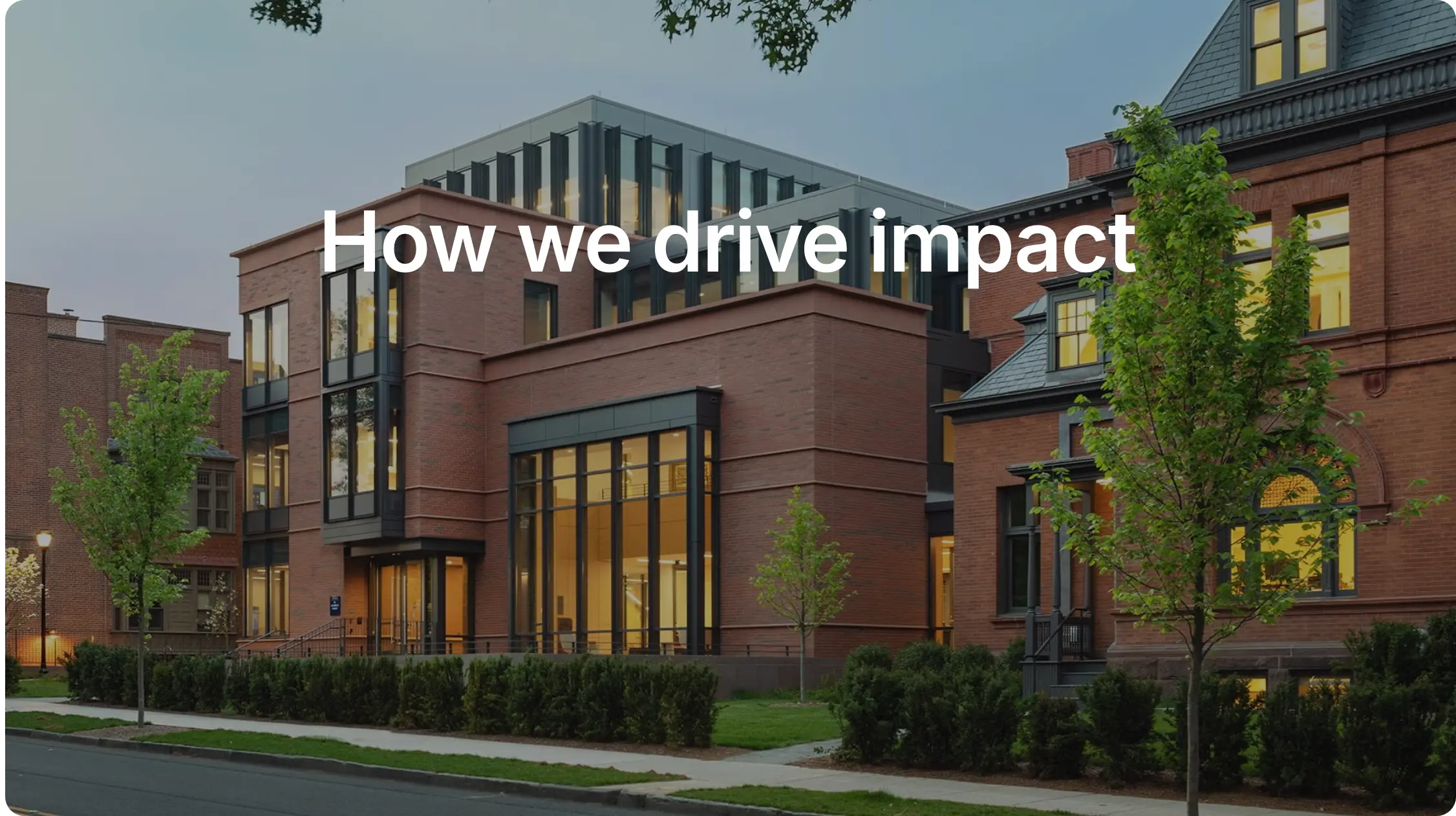 Red brick building with text that reads How we drive impact